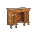A William and Mary kingwood, rosewood, oyster veneered and featherbanded kneehole desk in the man...