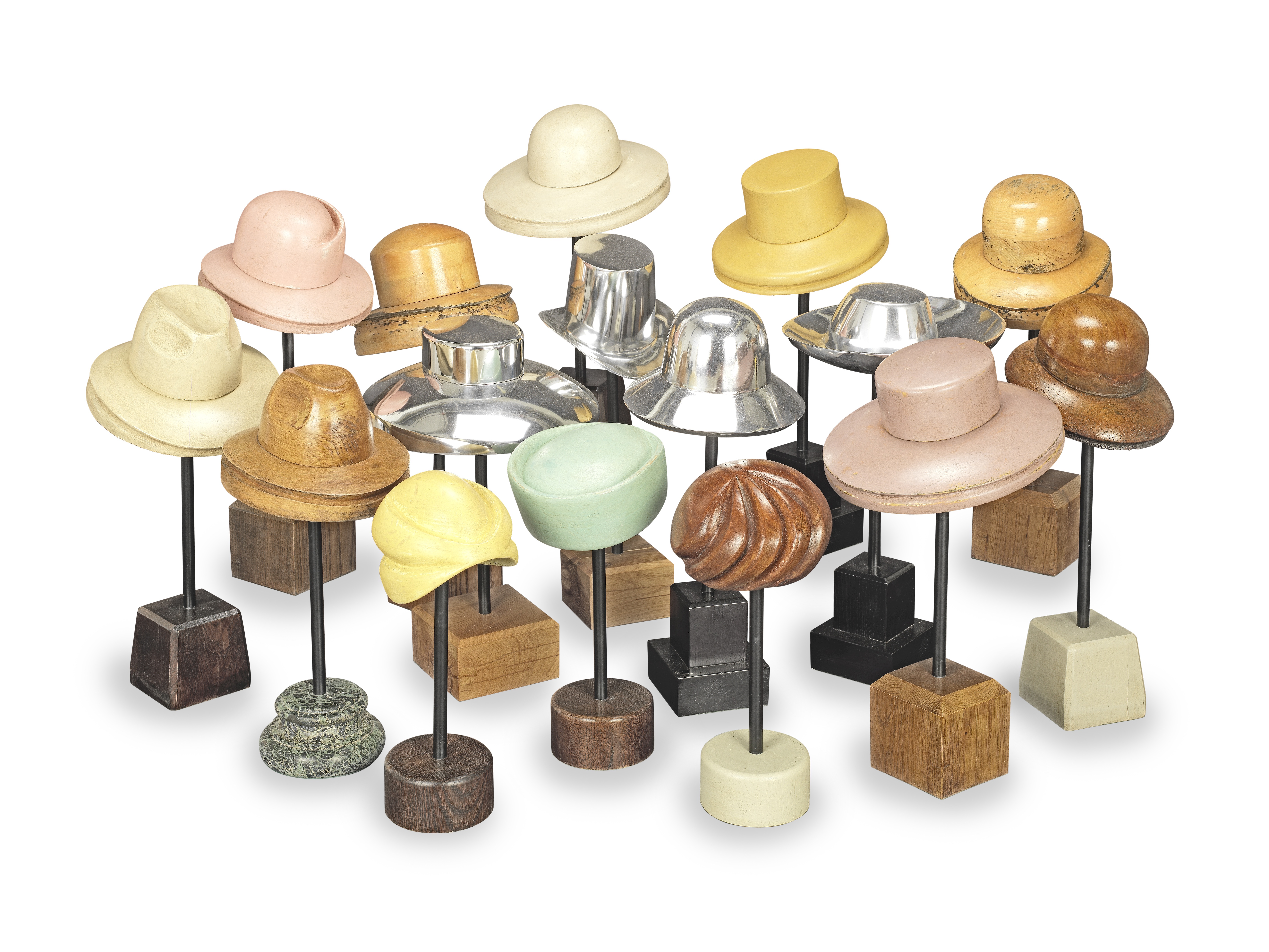 A collection of sixteen early to mid 20th century ladies and gentleman hat blocks on stands Engli...