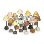 A collection of sixteen early to mid 20th century ladies and gentleman hat blocks on stands Engli...