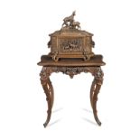 A good late 19th century Swiss 'Black Forest' carved linden wood liqueur cabinet with fitments on...