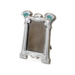 An Edwardian Art Nouveau silver and enamel photograph frame George Lawrence Connell, London 1903
