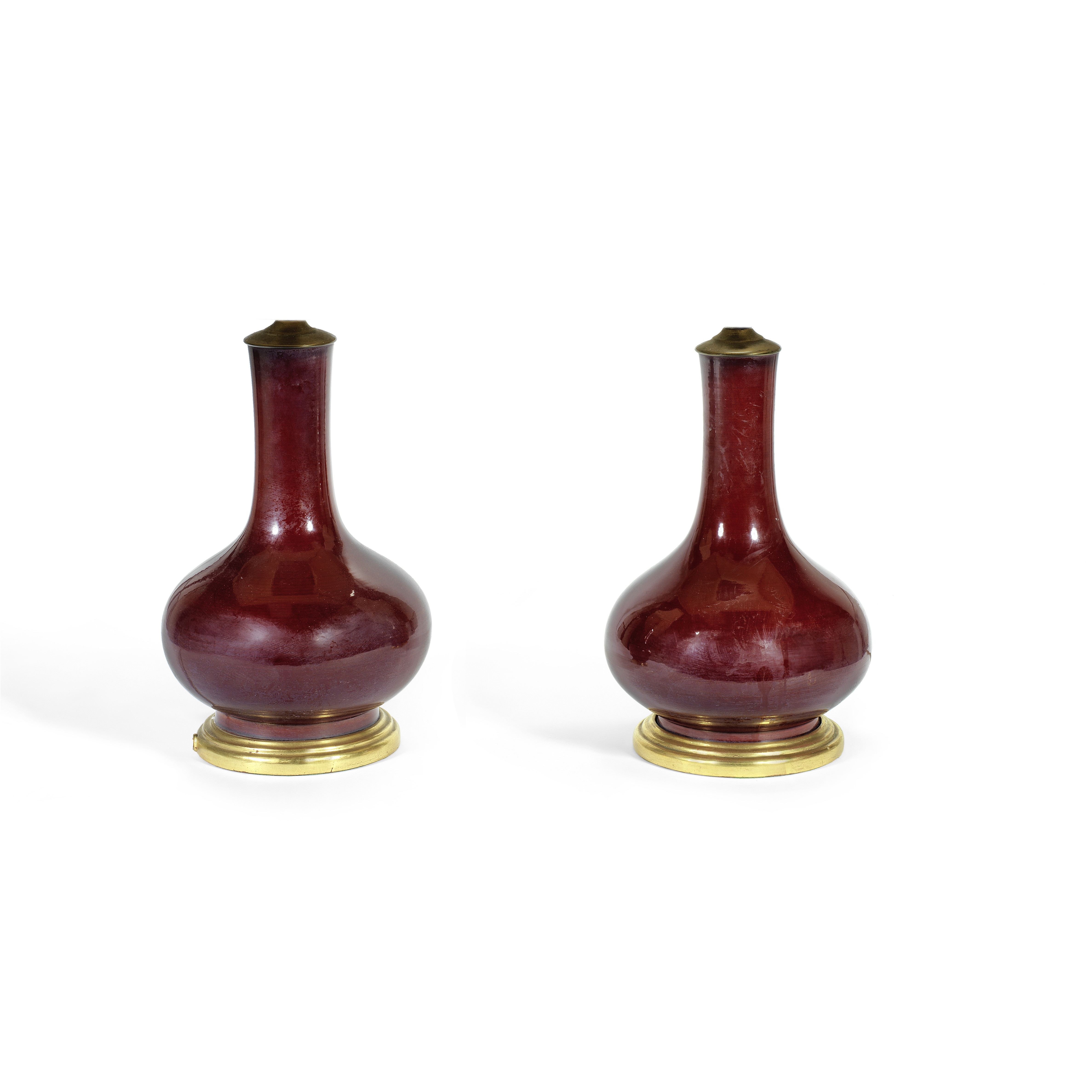 A pair of Chinese Sang de Boeuf glazed porcelain and vases, adapted as lamp bases the porcelain p...