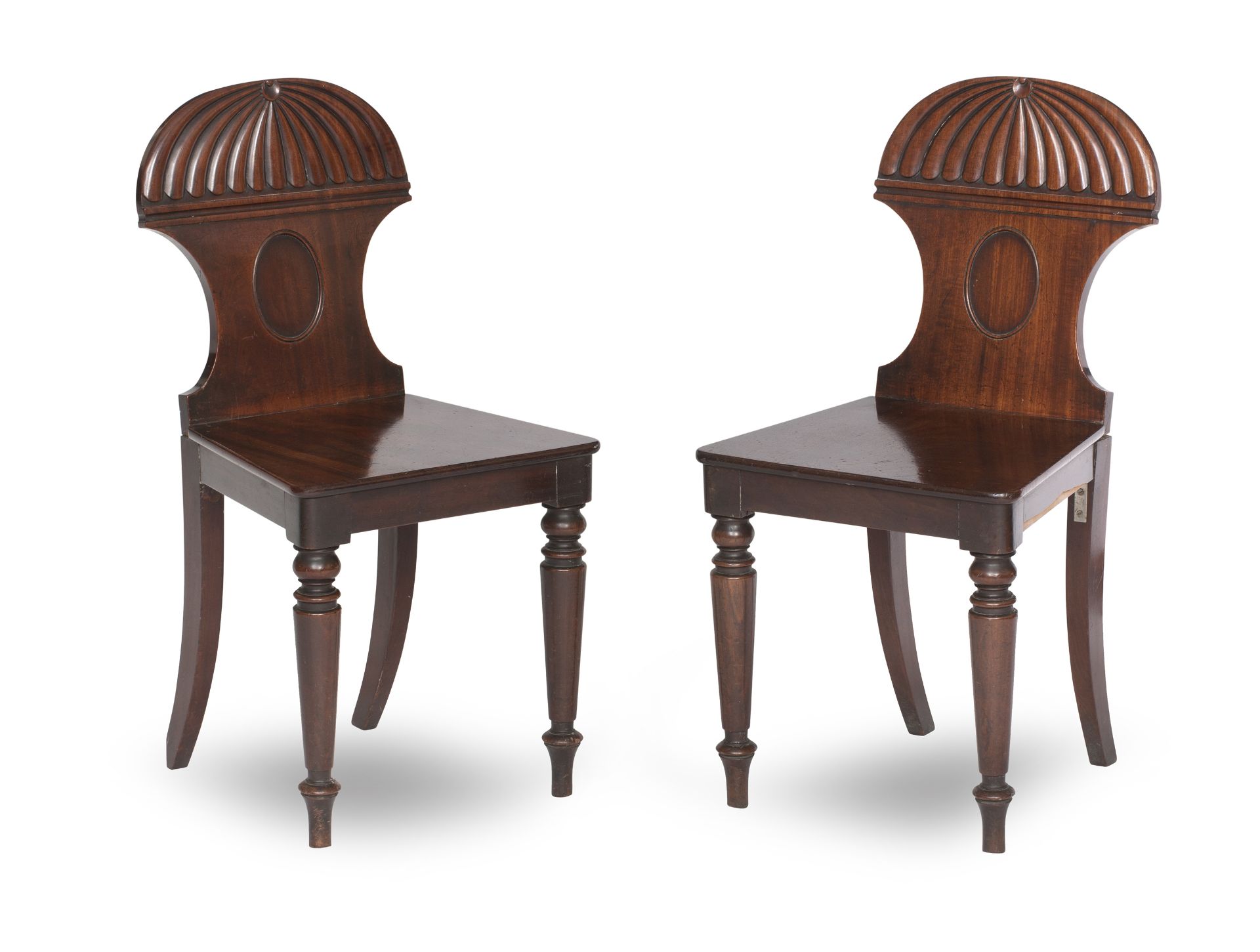 A pair of William IV mahogany hall chairs (2)