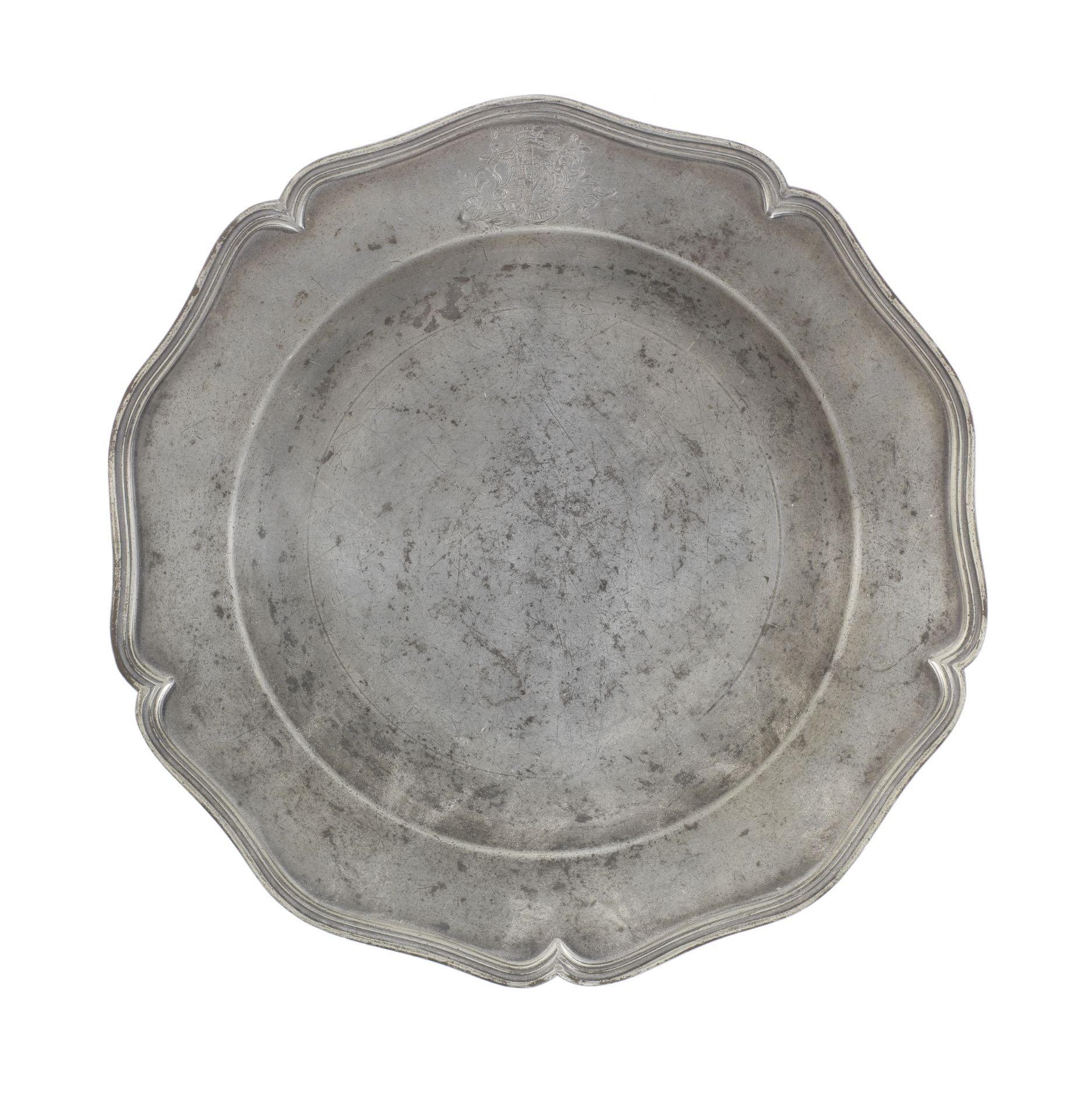 A George III pewter five lobed wavy edged armorial plate, circa 1770
