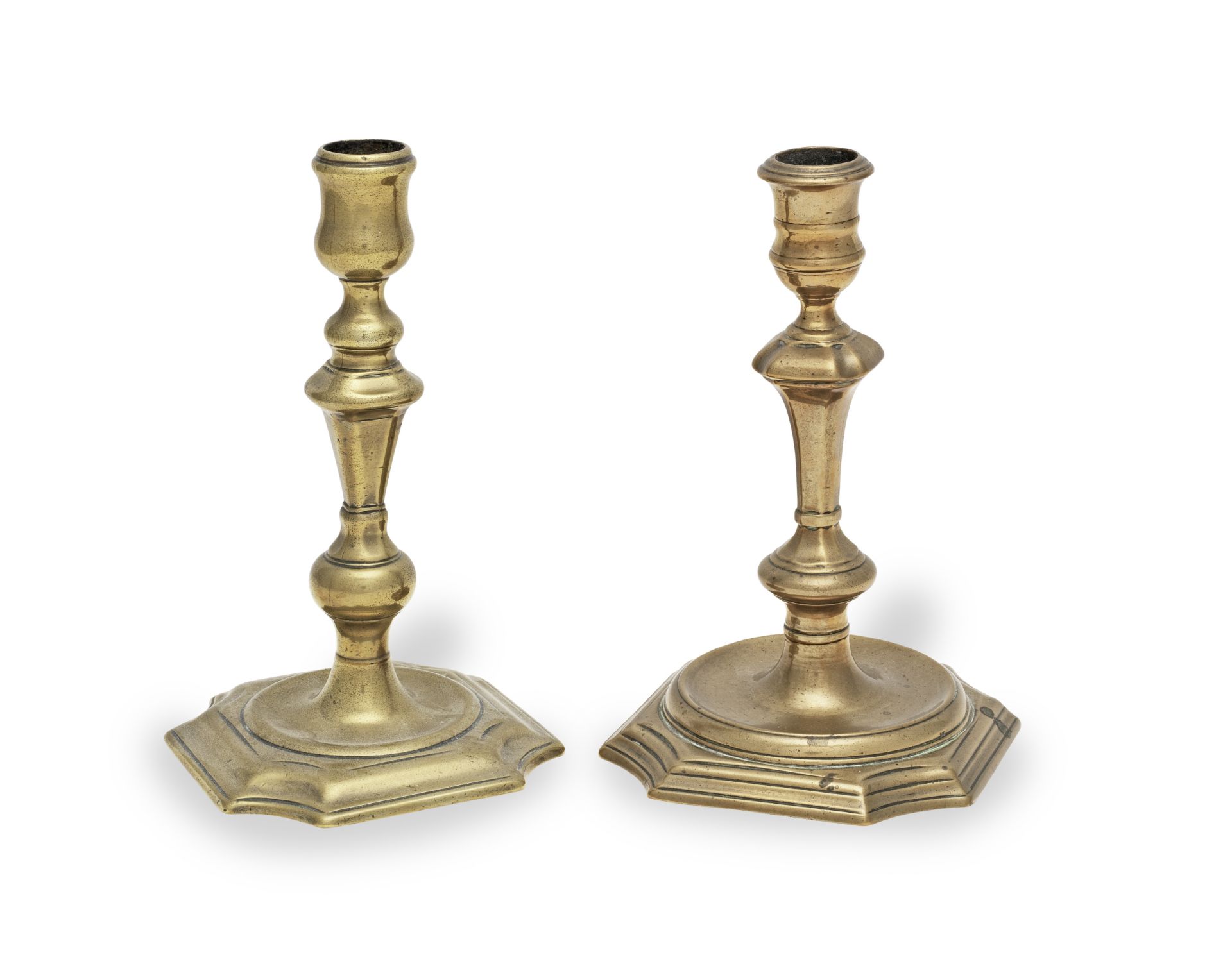 Two brass alloy socket candlesticks, circa 1725-40 (2)