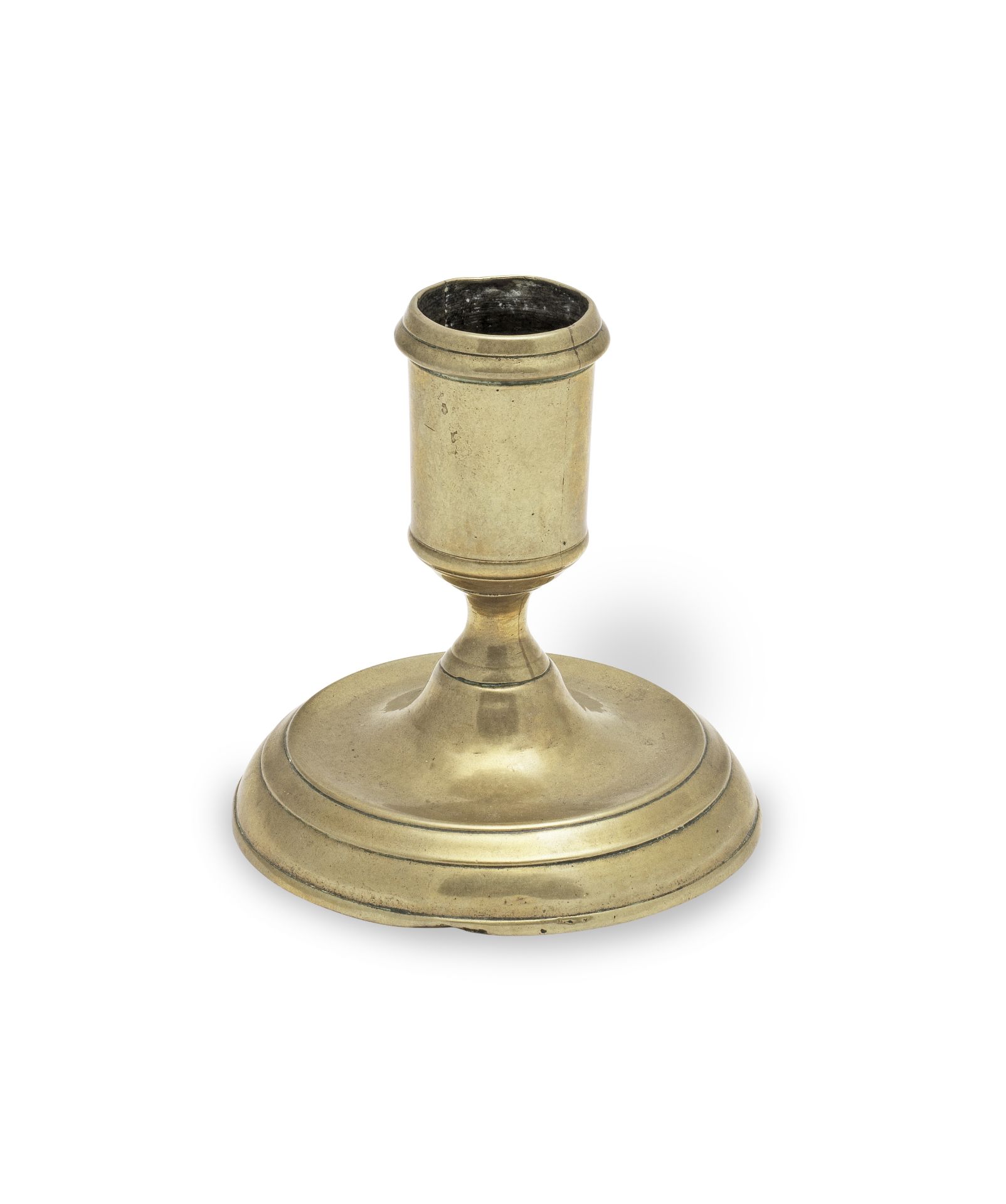 A George II brass dwarf candlestick, circa 1730-40 Possibly from a toilet service