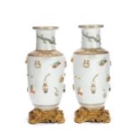 A PAIR OF MOULDED 'HUNDRED ANTIQUES' ROULEAU VASES Kangxi six-character marks, Qing Dynasty (2)