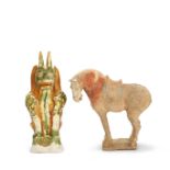 A SANCAI GLAZED POTTERY GUARDIAN AND A PAINTED POTTERY MODEL OF A HORSE Tang Dynasty (2)