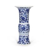 A BLUE AND WHITE 'LOTUS' BEAKER VASE, GU Late Qing Dynasty