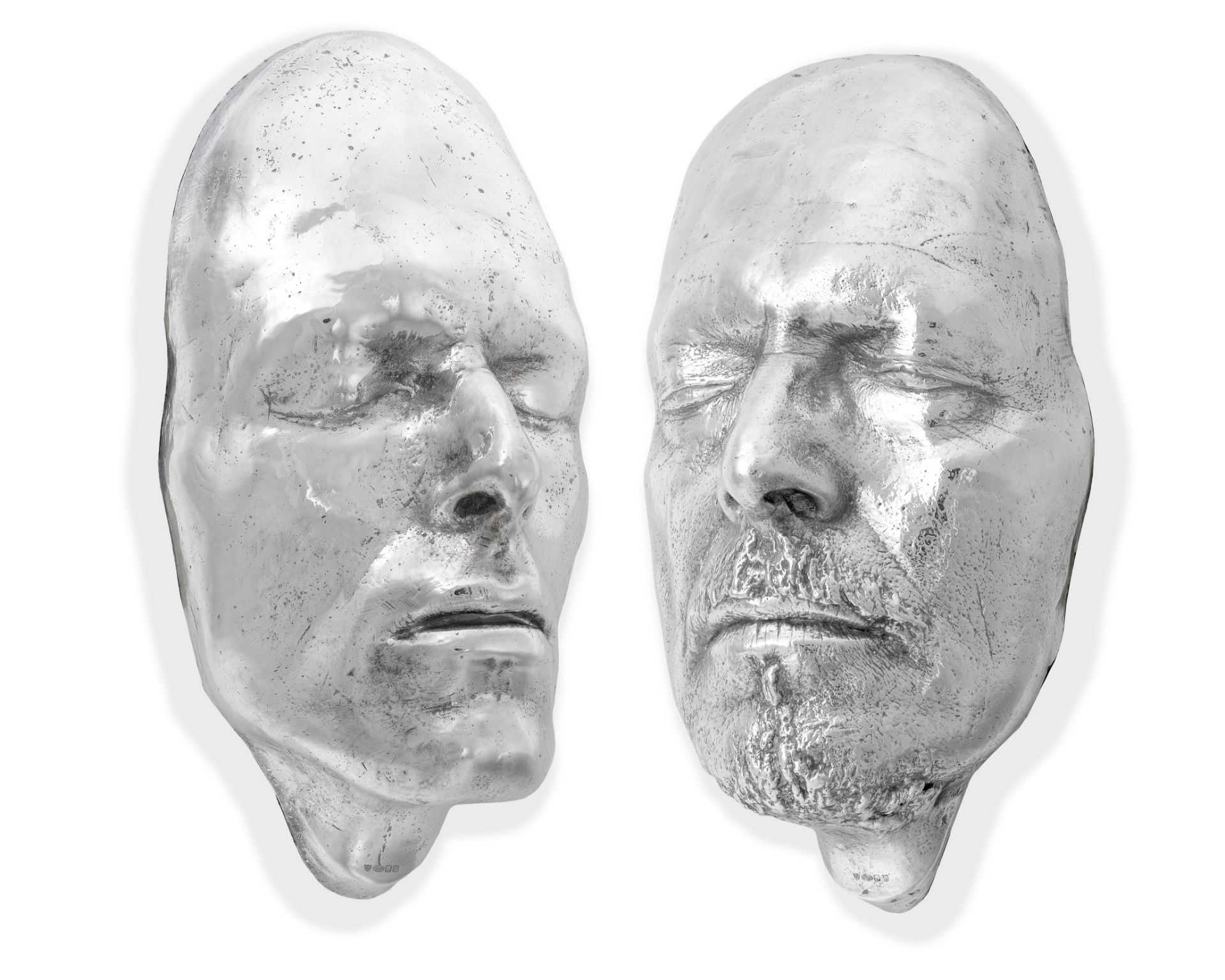 David Bowie (British, 1947-2016): Two Silver Shell and Resin Filled Lifemasks, 1975 & 1995,