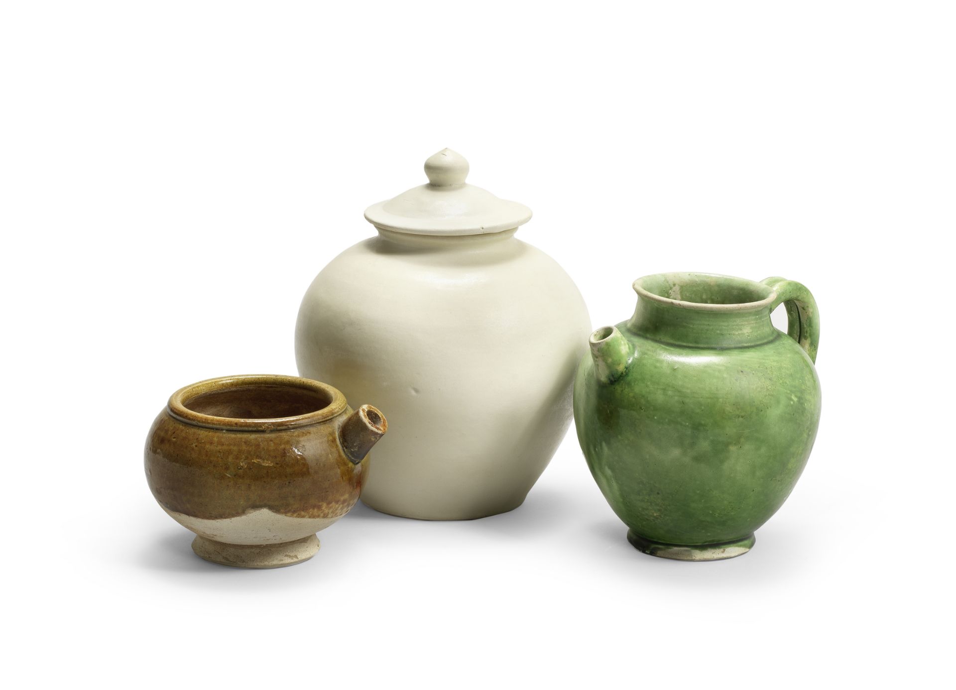 A CREAMY-WHITE-GLAZED JAR AND COVER AND TWO GREEN-GLAZED EWERS Tang Dynasty (3)