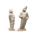 TWO PAINTED POTTERY FIGURES OF A GROOM AND A COURT LADY Tang Dynasty (2)