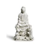 A BLANC-DE-CHINE FIGURE OF GUANYIN WITH TWO ACOLYTES 17th century