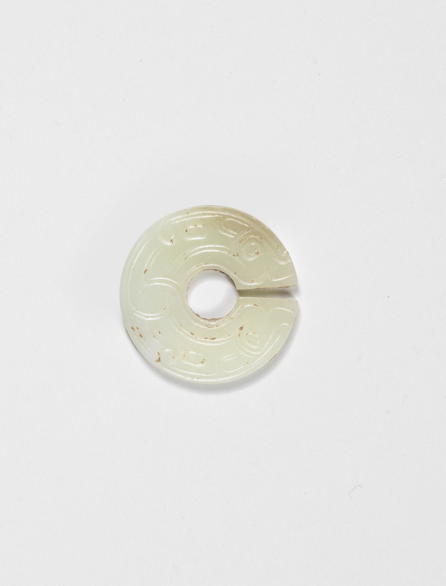 A RARE PALE GREEN JADE SLIT DISC, JUE Spring and Autumn Period