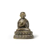 A COPPER-ALLOY COPPER-INLAID FIGURE OF A SAKYA LAMA 15th/16th century