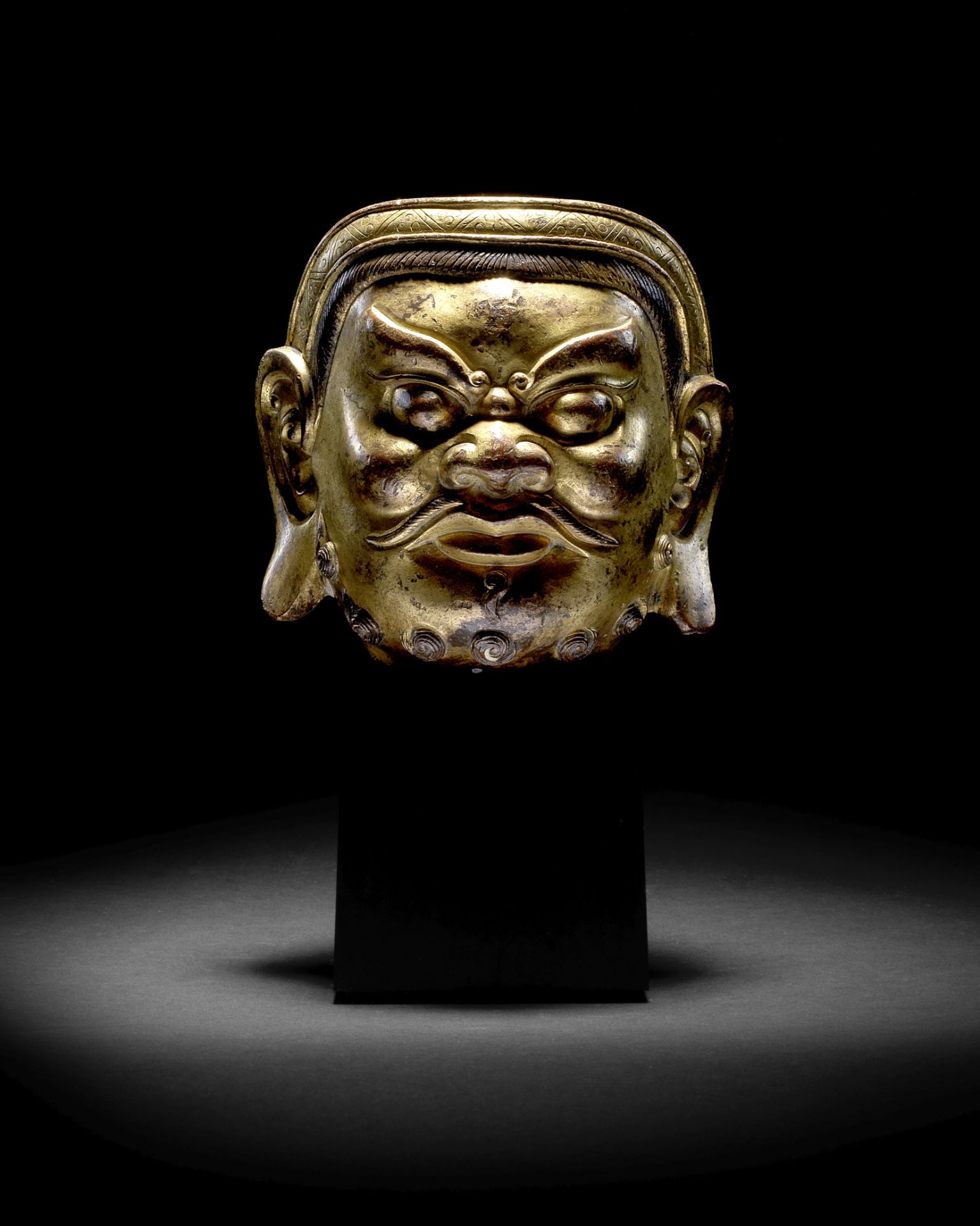 A RARE AND LARGE GILT-BRONZE HEAD OF A GUARDIAN Yuan/early Ming Dynasty (2)