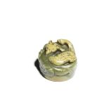 A RARE PALE GREEN AND RUSSET JADE 'MYTHICAL BIRD' SCROLL WEIGHT Tianji Wenbao incised four-charac...