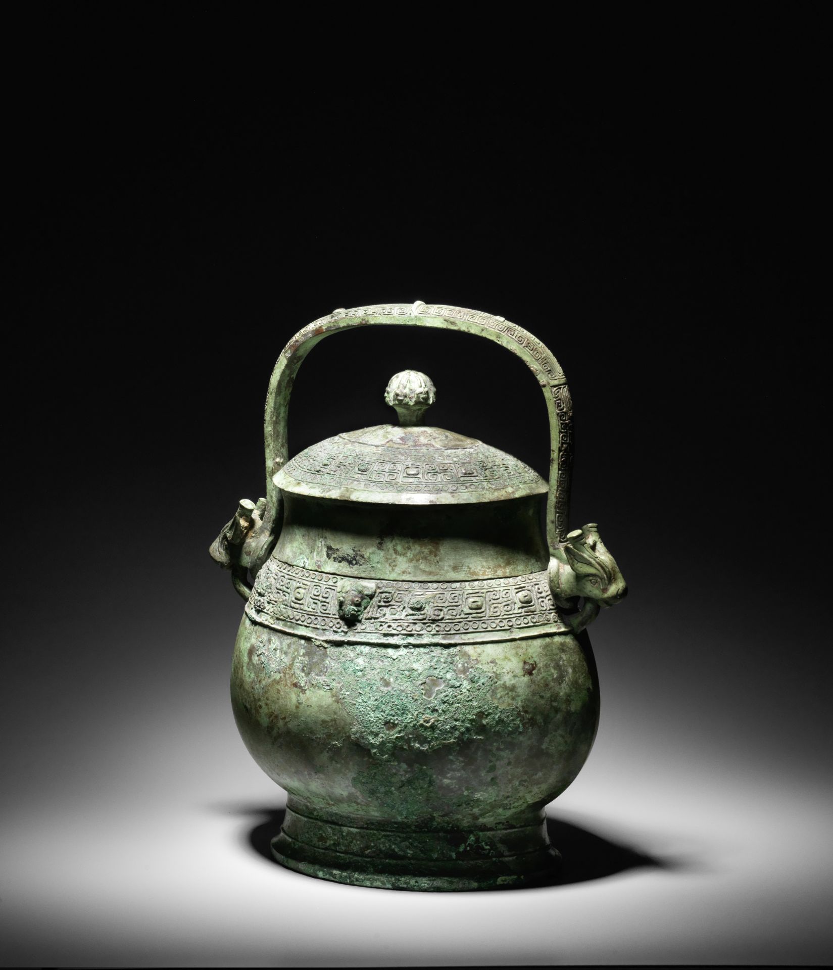 A VERY RARE ARCHAIC BRONZE RITUAL WINE VESSEL AND COVER, YOU Early Western Zhou Dynasty, 10th cen...