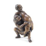 A large boxwood netsuke of two sumo wrestlers By Unhodo Masayoshi, Meiji era (1816-1912), circa 1890