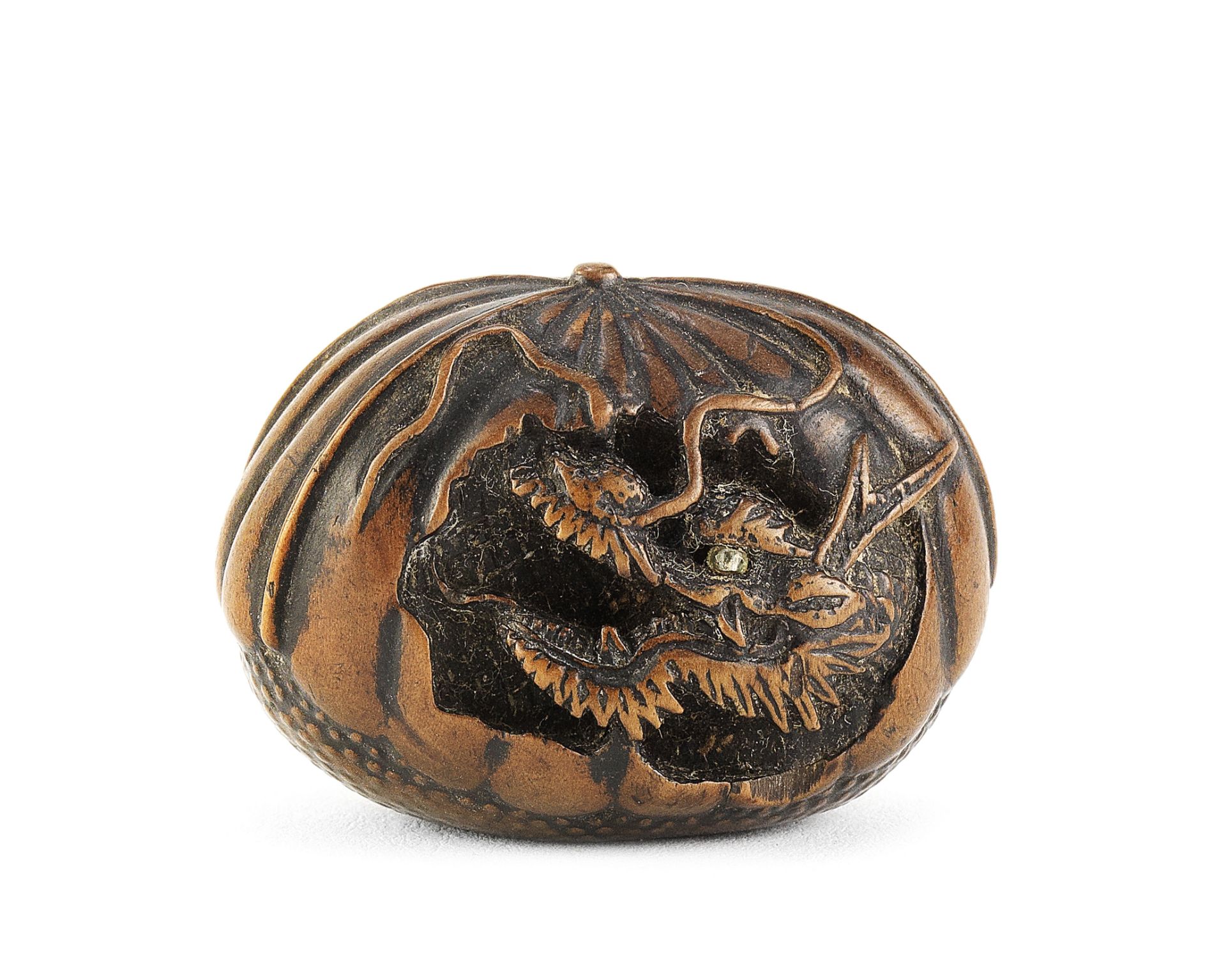 A wood netsuke of a dragon in a chestnut By Toyoyasu (Toyoyo), Edo period (1615-1868), Sasayama, ...