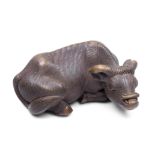 A wood netsuke of a recumbent ox By Masanao, Kyoto, Edo period (1615-1868), late 18th century