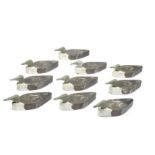 A flotilla of ten painted wooden decoy ducks
