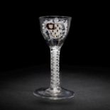 The Surtees Marriage Glasses: a rare enamelled armorial wine glass from the Beilby workshop, circ...