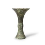 A RARE ARCHAIC BRONZE RITUAL WINE VESSEL, GU Late Shang Dynasty