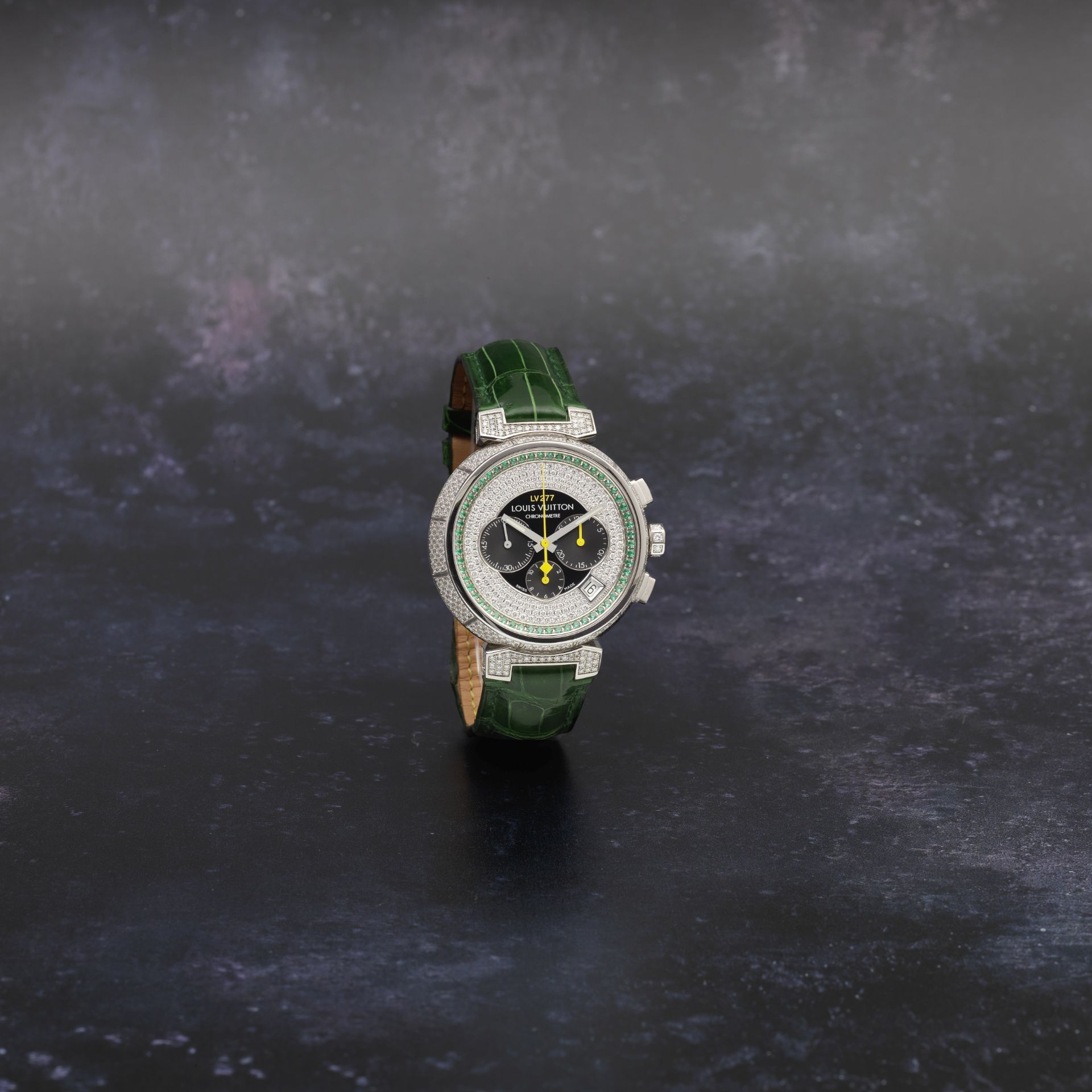 Louis Vuitton. An 18K white gold, diamond and emerald set automatic calendar chronograph wristwat...