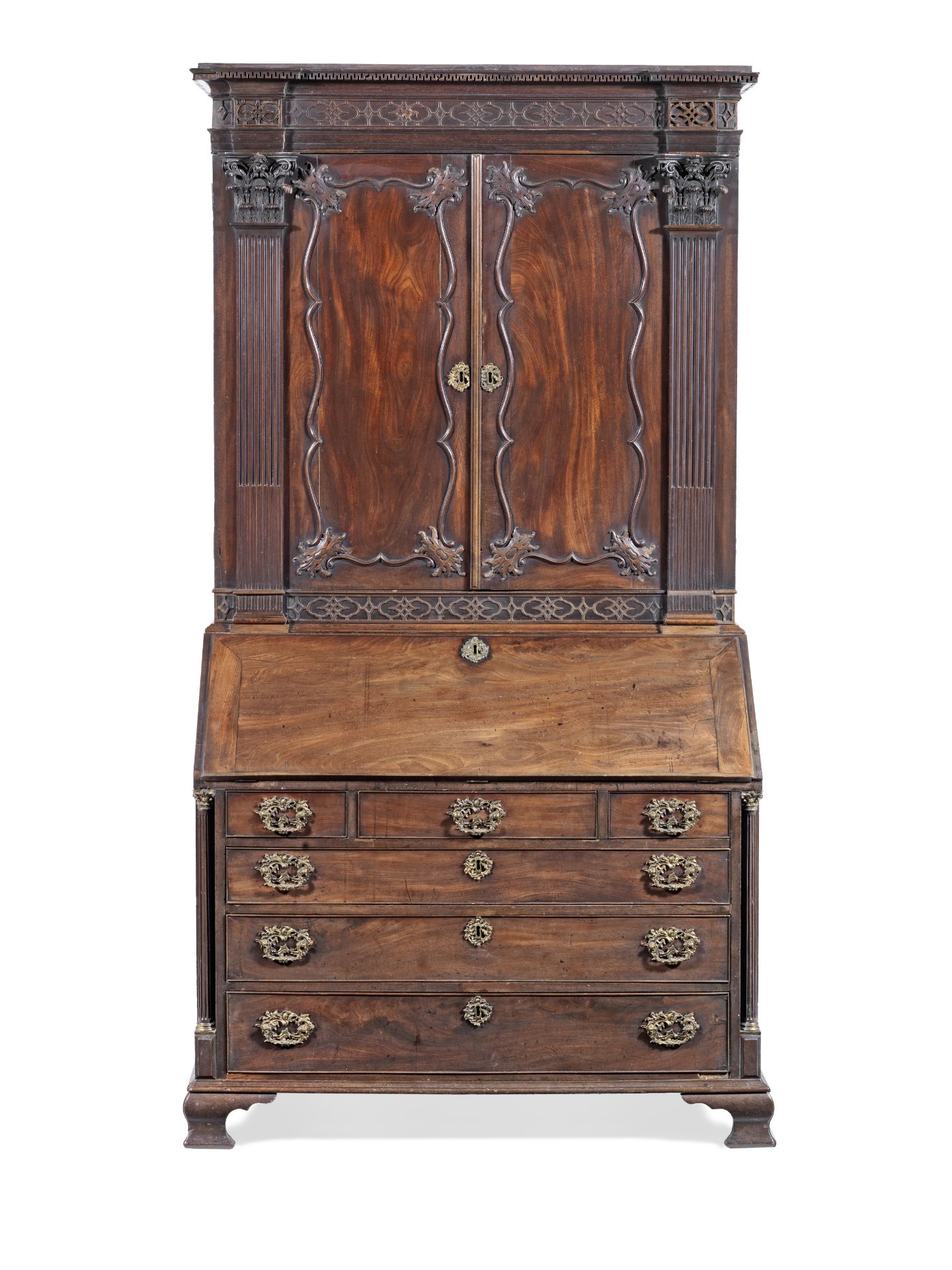 A George III carved mahogany and ormolu mounted bureau cabinet attributed to Gillows the carving...