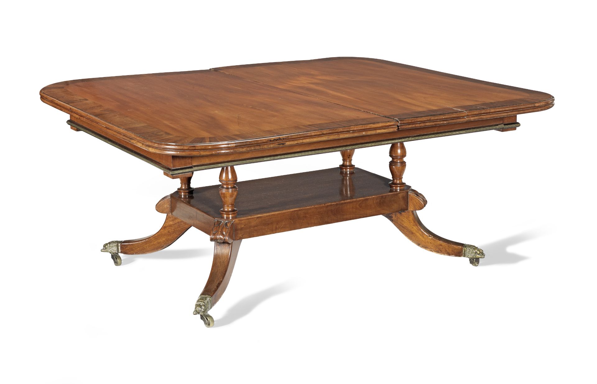 An Irish Regency mahogany and rosewood banded extending dining table possibly by Mack, Williams a...