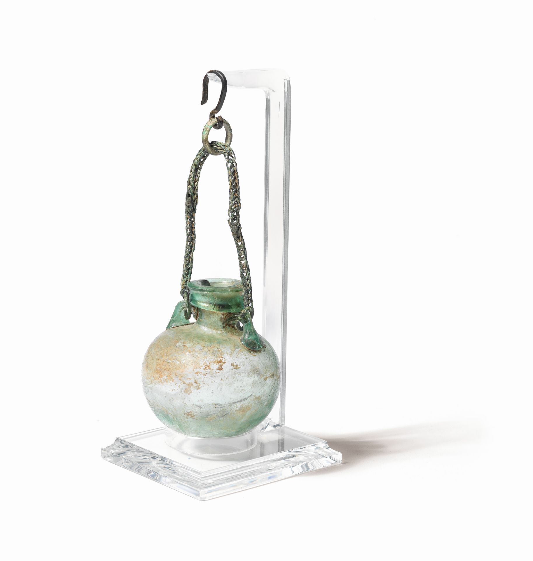 A Roman green glass aryballos with bronze link chain