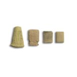 A Sumerian terracotta cuneiform foundation cone, a Sumerian terracotta cuneiform tablet, and two ...