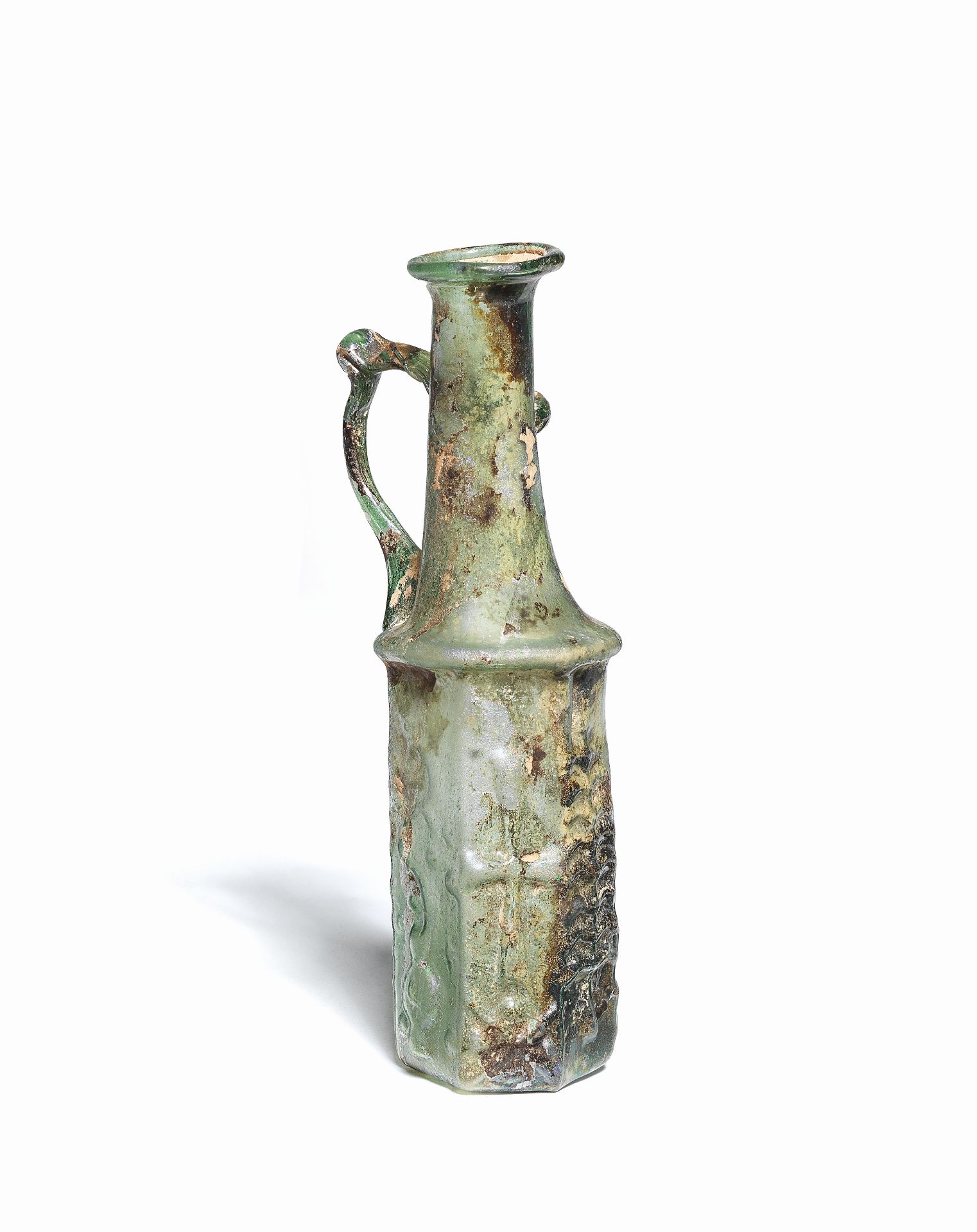 A Byzantine green glass hexagonal pitcher with Christian symbols