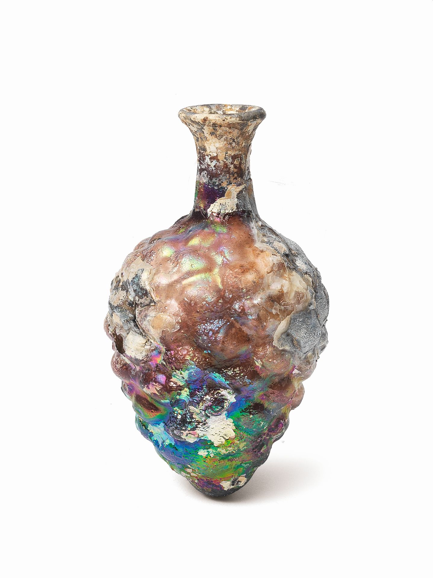 A Roman purple glass pine cone-shaped bottle