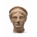 A large Etruscan terracotta head of a female