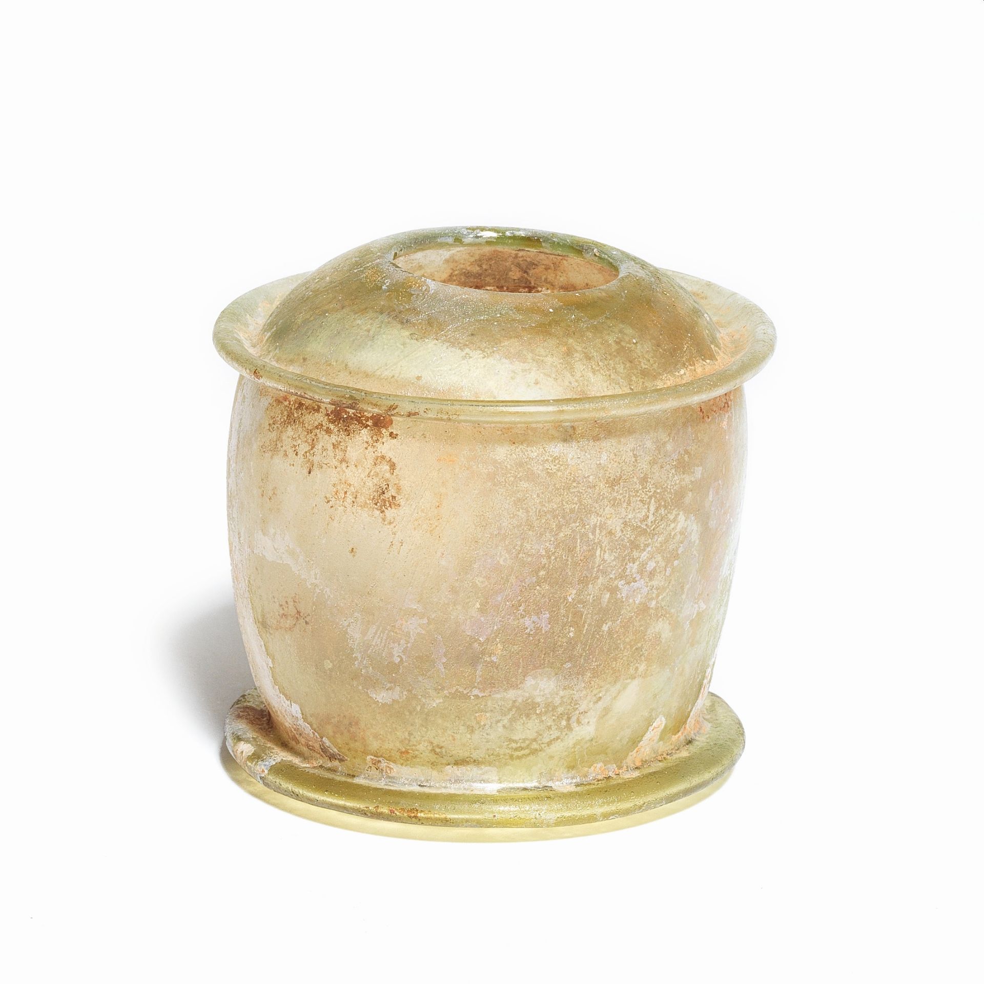 A Roman yellow-green glass pyxis