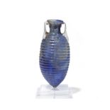 A Roman mould-blown blue glass ribbed amphoriskos with opaque white applied twin handles