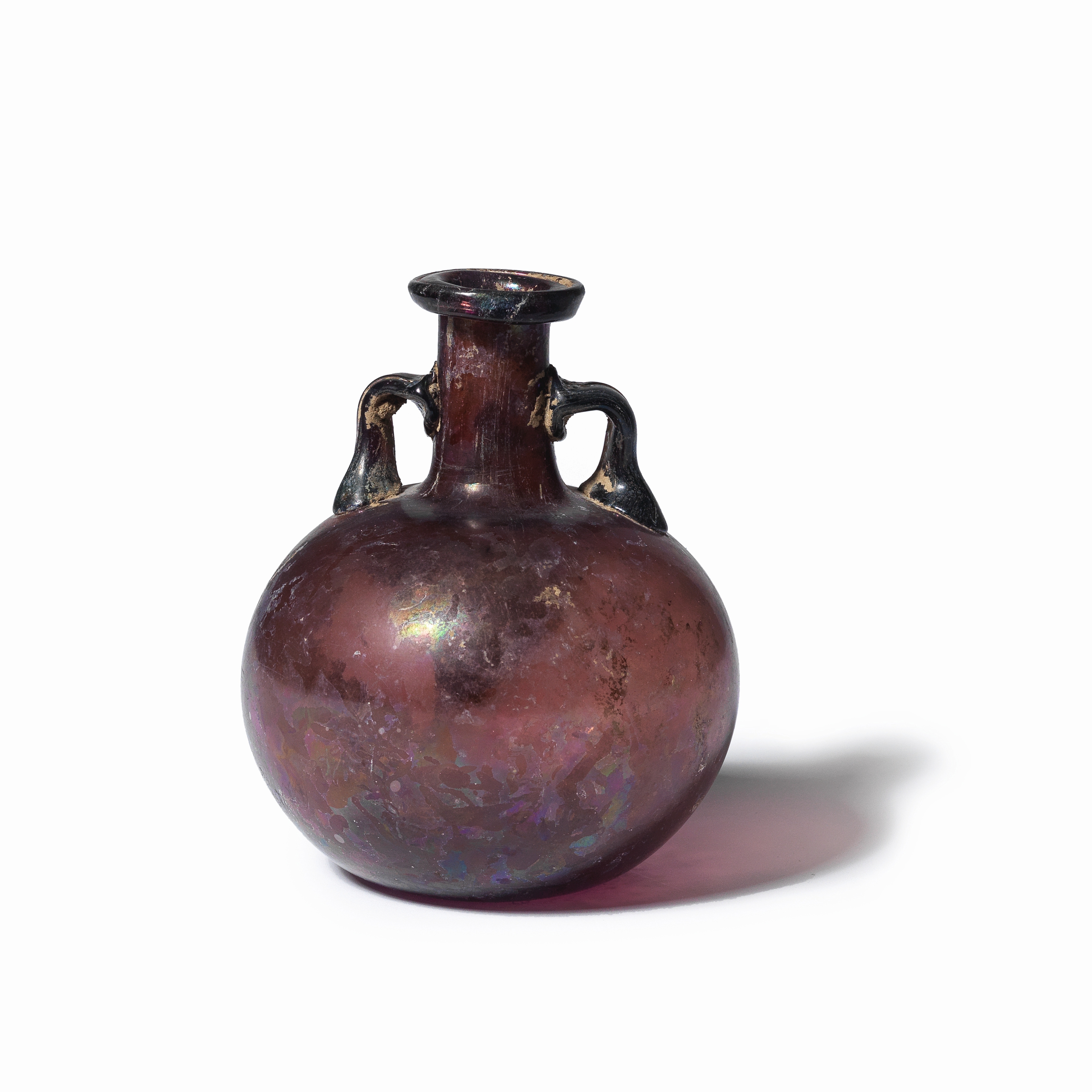 A large Roman aubergine glass aryballos