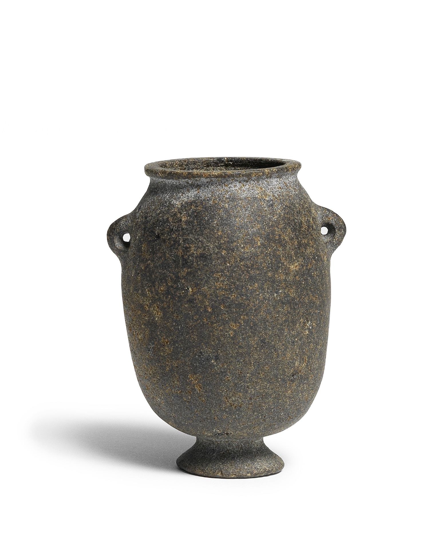 An Egyptian basalt footed jar