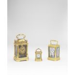 A good late 19th century French engraved brass repeating carriage clock with three porcelain pane...
