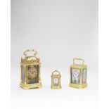 A good 19th century French miniature engraved brass oval carriage timepiece set with four shaped ...