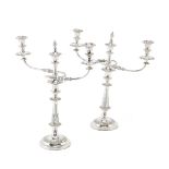 A pair of Old Sheffield plate three-light candelabra, and a pair of candlesticks en suite (4)