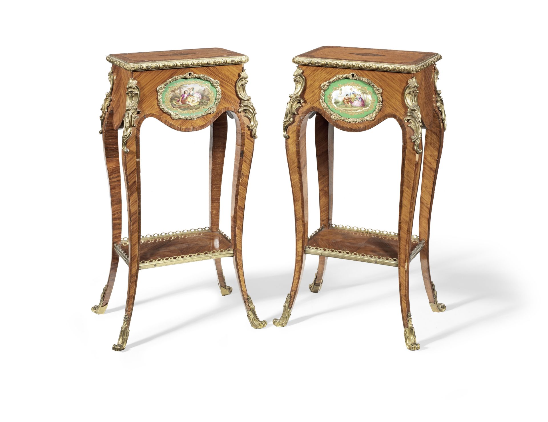 A pair of early Victorian porcelain and ormolu mounted tulipwood, kingwood and rosewood tables or...