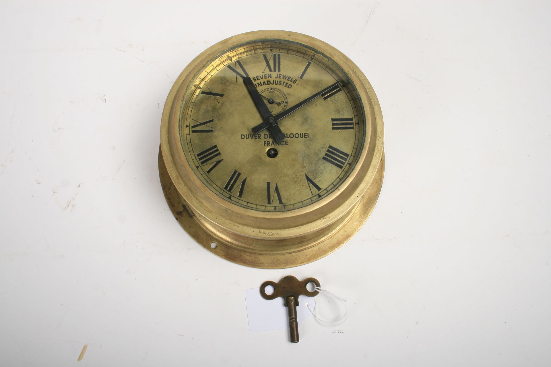 A brass bulkhead clock by Duver Drey Bloquel of France, ((2))