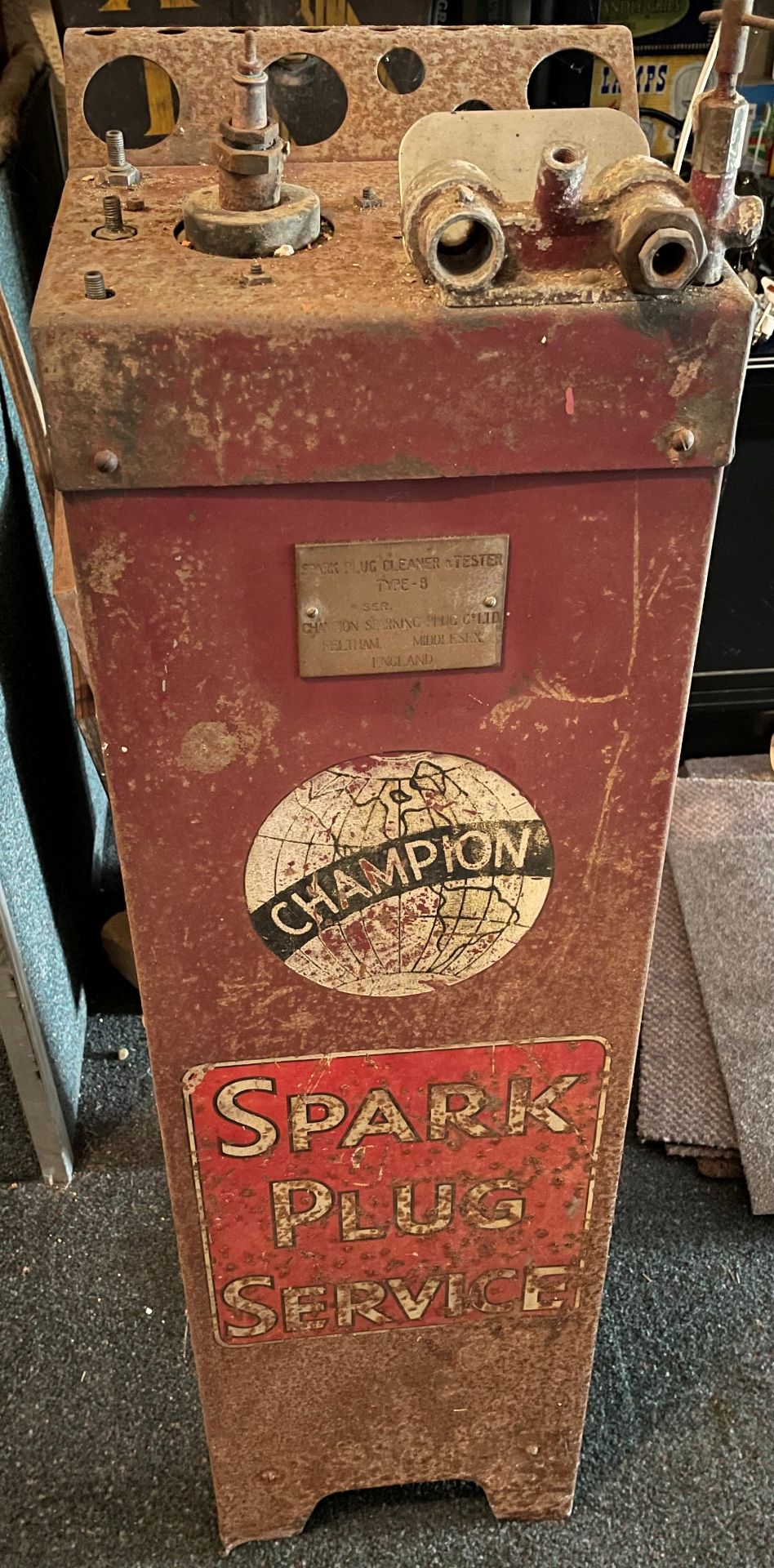 A 'Champion Spark Plug Service' stand,