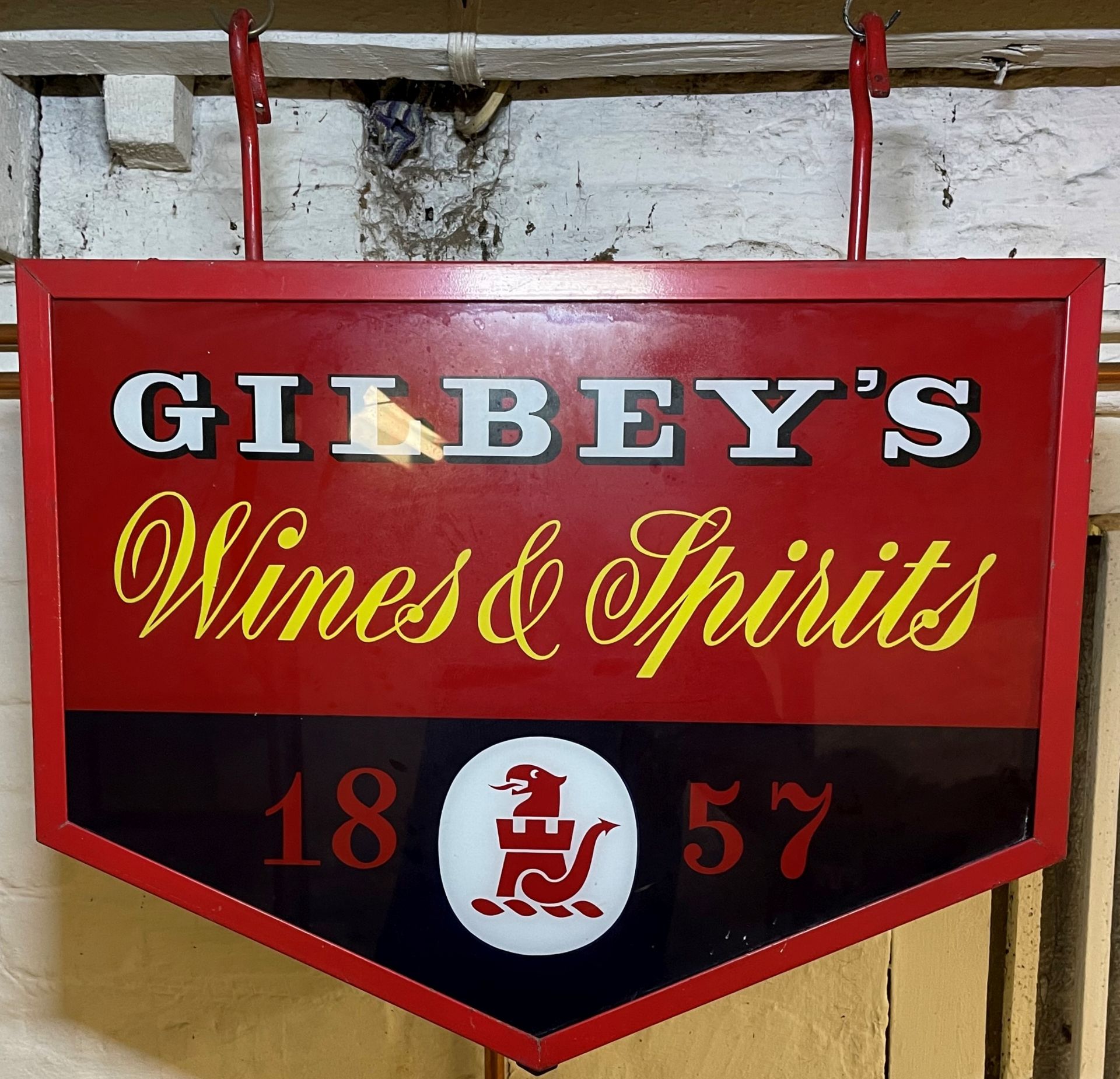 A Gilbey's Wine & Spirits illuminated hanging sign,