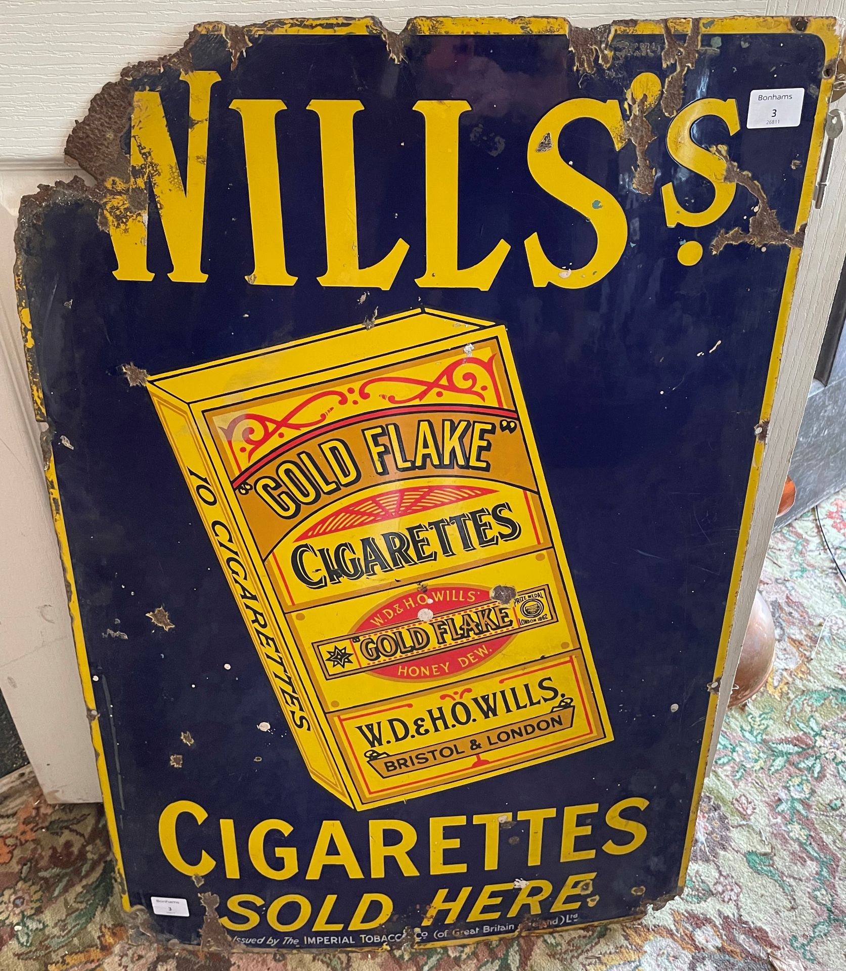 A 'Wills Gold Flake Cigarettes' enamel sign,