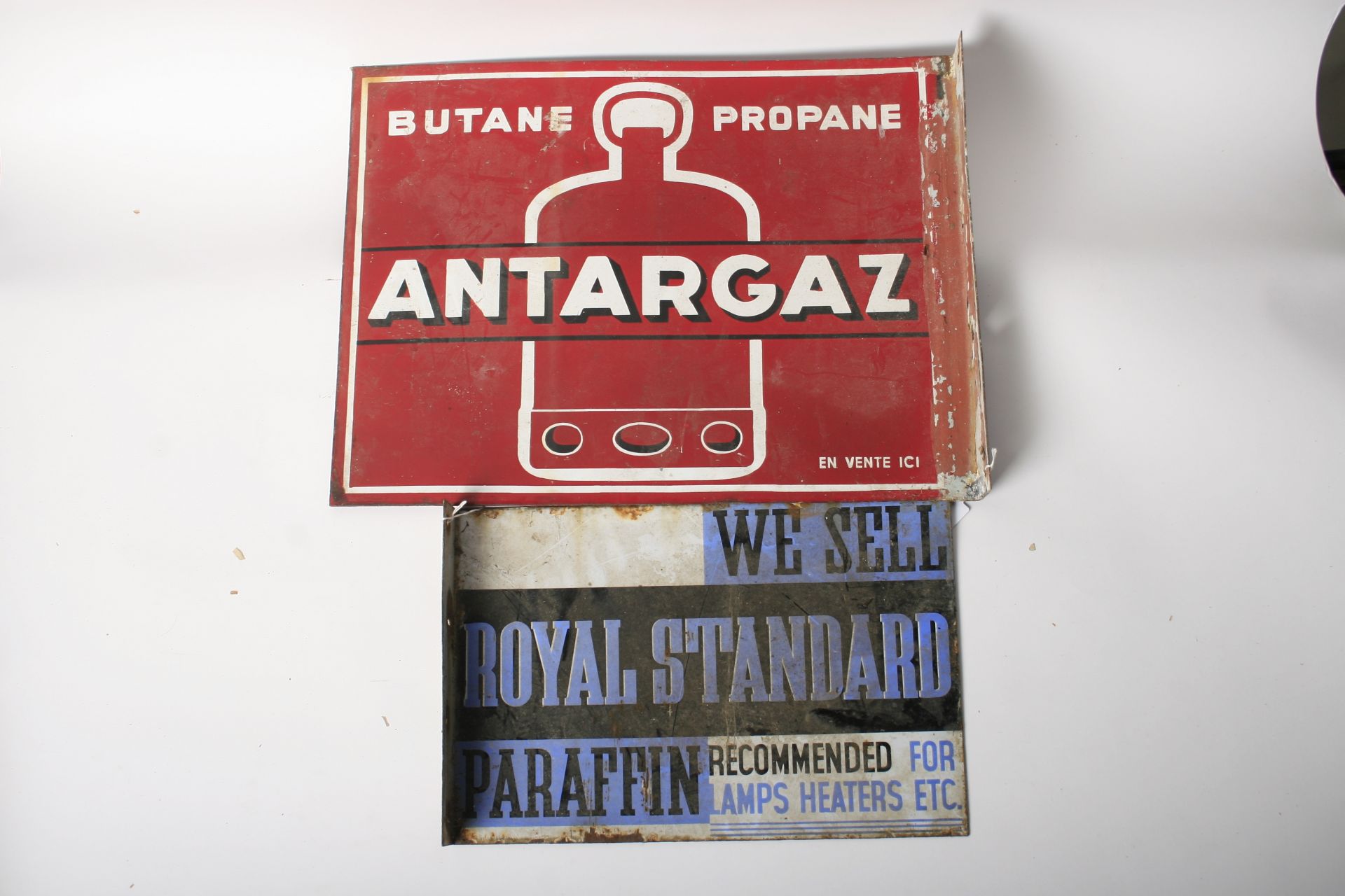 Two flange-mounted double-sided enamel signs, ((2))