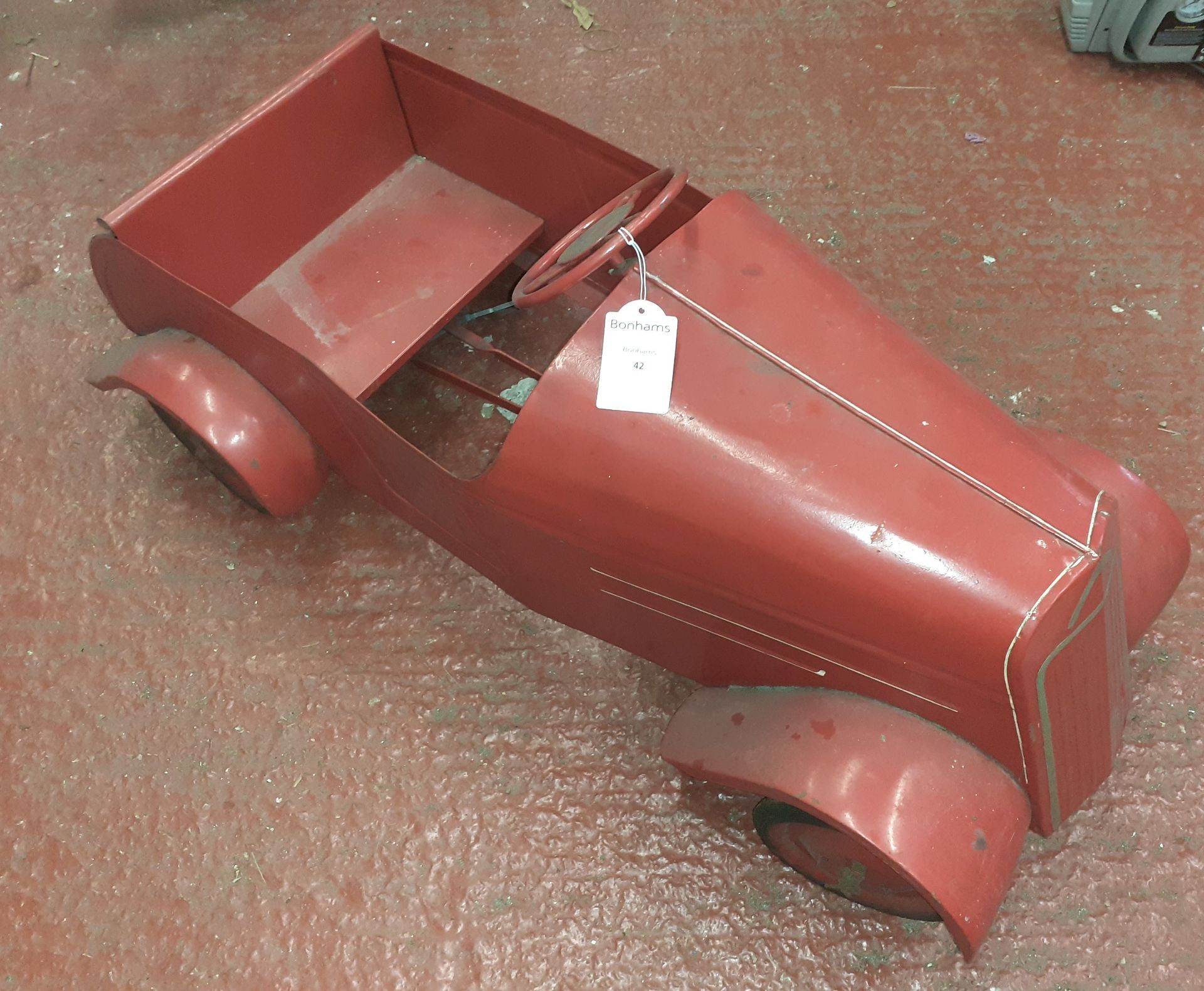 A steel bodied pedal car,